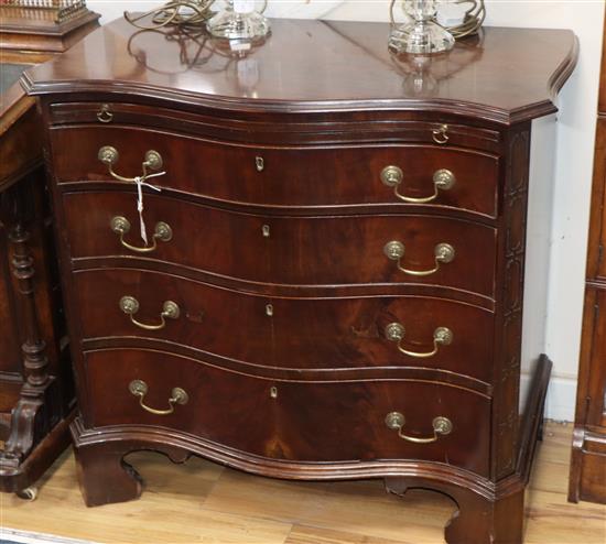 A George III style mahogany serpentine chest of drawers W.90cm